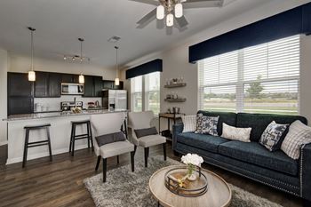 an open living room and kitchen with a couch and a table  at Watermark on Twenty Mile, Colorado, 80134